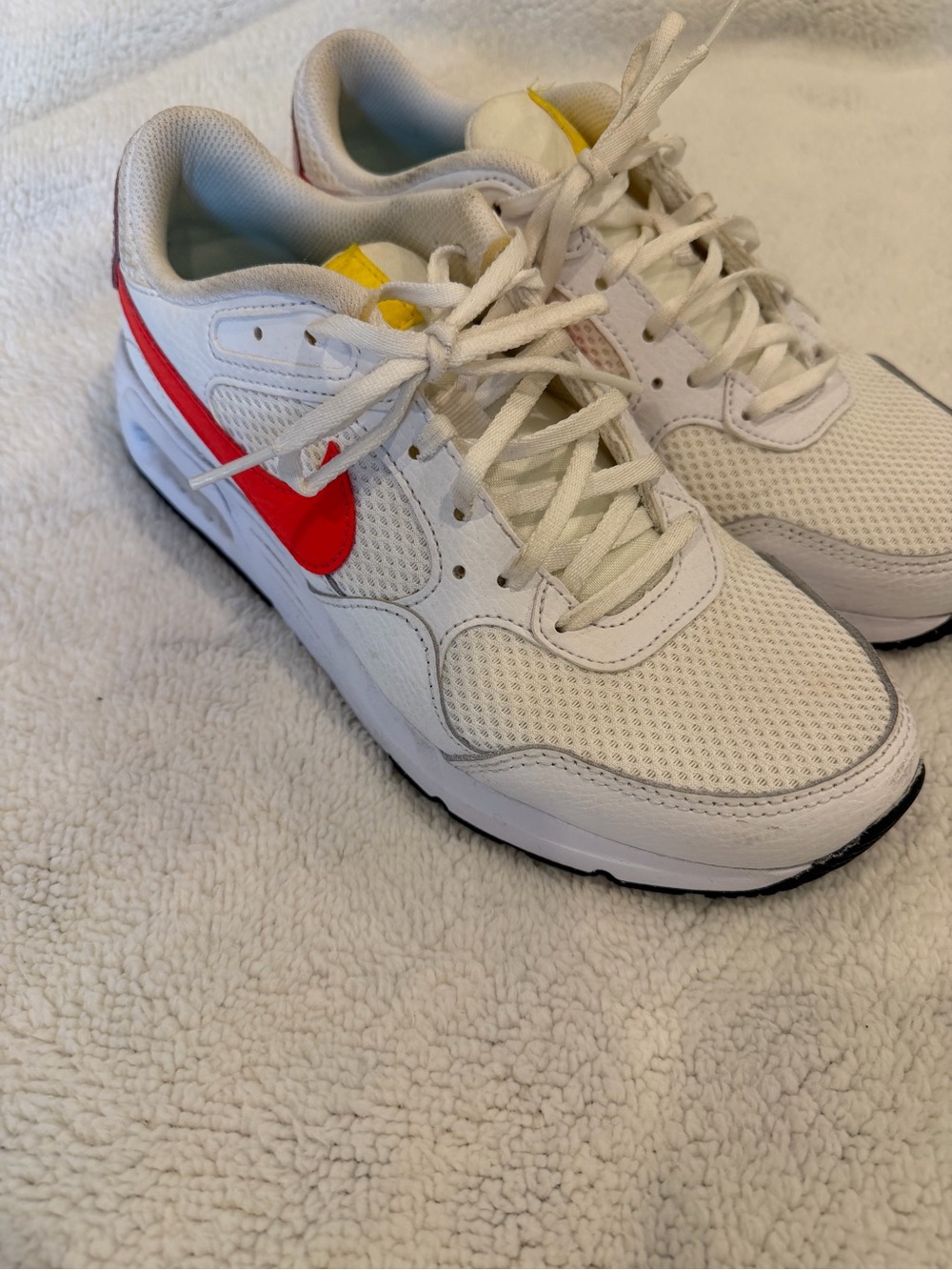 Nike Kids White Sneakers with Red Swoosh and Yellow Tongue Accent